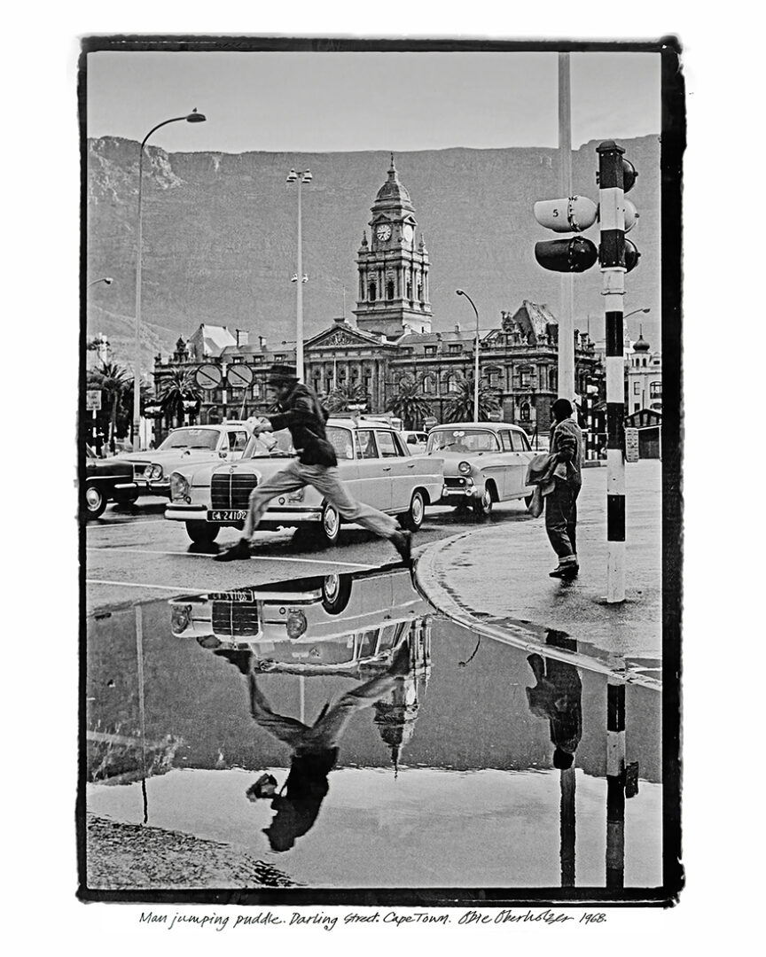 Obie Oberholzer | Man Jumping Puddle, Darling Street, Cape Town, 1968